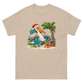 Sand-colored Mellow Moonfish T-shirt with a Santa-hat pelican in a teal beach chair beside a decorated palm tree